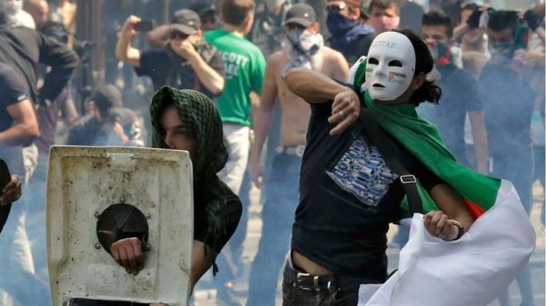 Pro-Palestinian protesters throw projectiles during a demonstration against violence in the Gaza strip in Paris